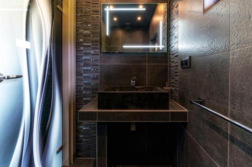 a bathroom with a brown sink and a mirror at Luxury holiday villa, pool, sauna, jacuzzi in Nowy Targ