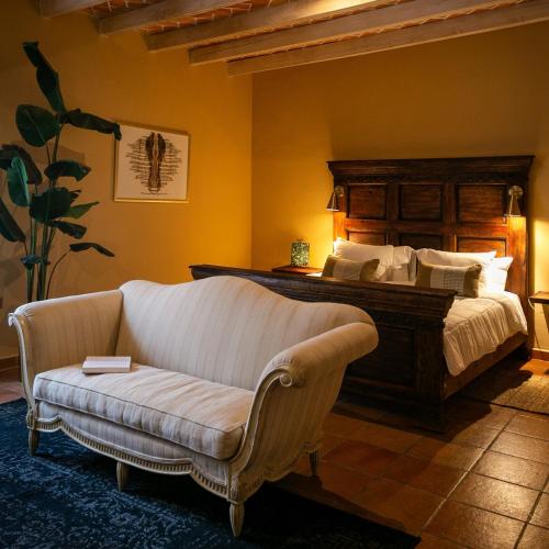 a bedroom with a bed and a couch and a bed at Habibi Hotel and SPA in San Miguel de Allende