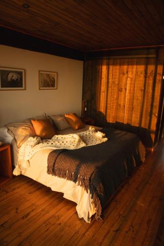a bedroom with a large bed in a room at Hotel Punta Sirena in Curanipe