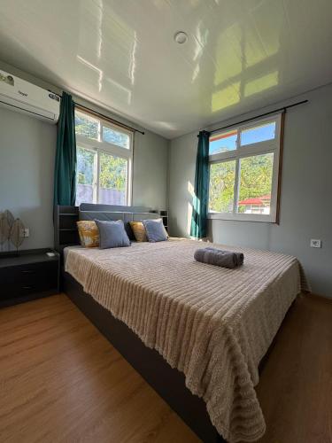 a bedroom with a large bed with a blanket at Villa Blue Lagoon Tahaa in Tahaa