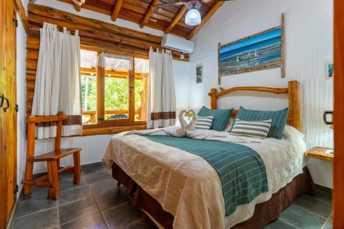 a bedroom with a large bed in a room at Cabañas Mapuche in Mar de las Pampas