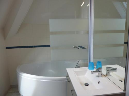 a white bathroom with a sink and a toilet at Gîte de charme à la campagne - 6 pers. - FR-1-489-17 in Bagneux