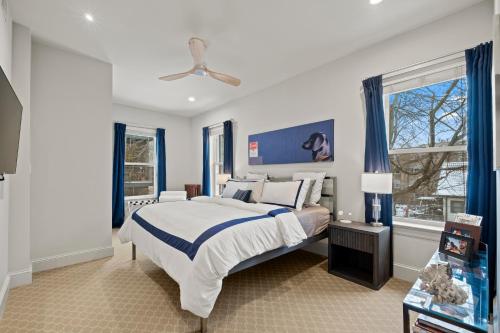 a bedroom with a large bed with blue curtains at Elegant and Chic 2Bed 2Bath steps from the lake! in Chicago