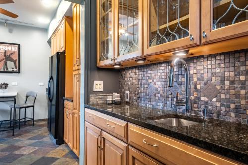 a kitchen with a sink and a refrigerator at Elegant and Chic 2Bed 2Bath steps from the lake! in Chicago