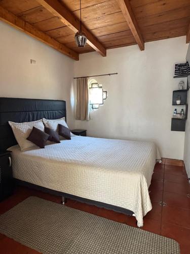 a bedroom with a large bed in a room at Zoola Suites Antigua in Antigua Guatemala