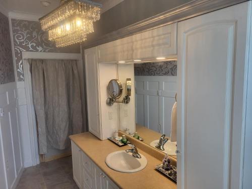 a bathroom with two sinks and a large mirror at The Tamworth Hotel, Tamworth ,Ontario, Canada in Tamworth
