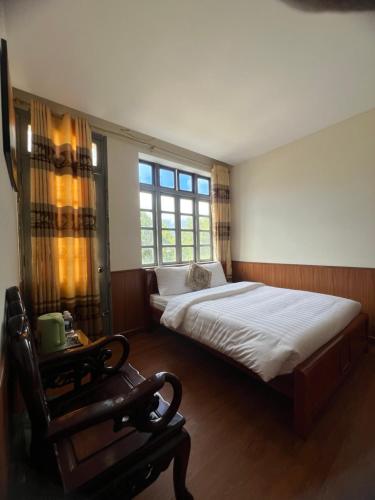 a bedroom with a large bed and a window at TINH DOI SA PA Guest House in Sapa