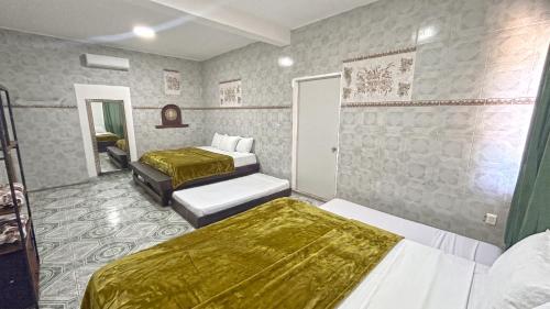 Llit o llits en una habitació de Hotel Real Maya