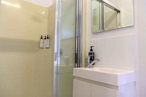 a bathroom with a sink and a shower at Weipa Motel Resort in Weipa