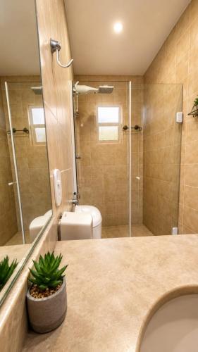 a bathroom with a sink and a shower and a toilet at Pousada Mojomar Buzios in Búzios