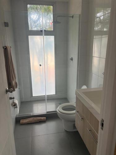 a bathroom with a shower and a toilet and a window at Relax Terrace Condo Near Coronado Beaches in El Creo