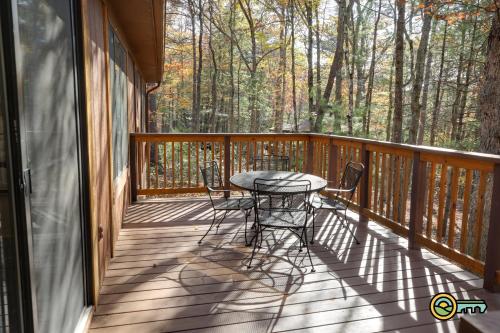 a wooden deck with a table and chairs on it at Villa #114 in Basye