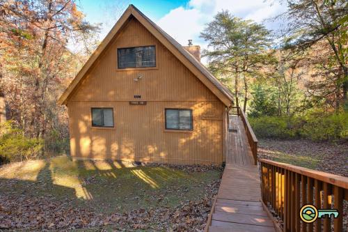 a large wooden house with a wooden walkway to it at Villa #119 in Basye