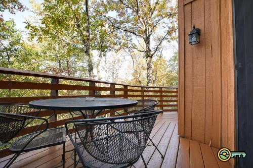 a porch with a table and chairs on a deck at Villa #102 in Basye