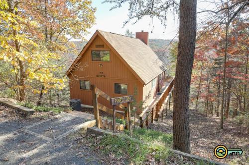 a cabin in the woods with a stairway leading up to it at Villa #364 in Basye