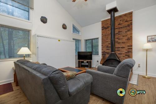 a living room with a couch and a fireplace at Senedo Springs Duplex #101A in Basye
