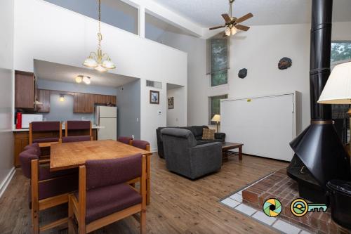 a kitchen and living room with a table and a couch at Senedo Springs Duplex #101A in Basye