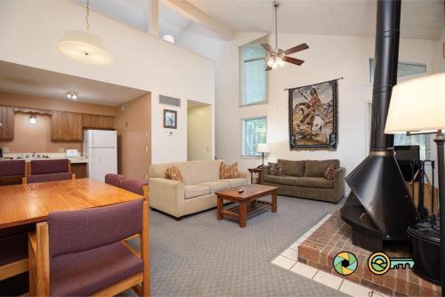 a living room with a fireplace and a dining room at Senedo Springs Duplex #97A in Basye