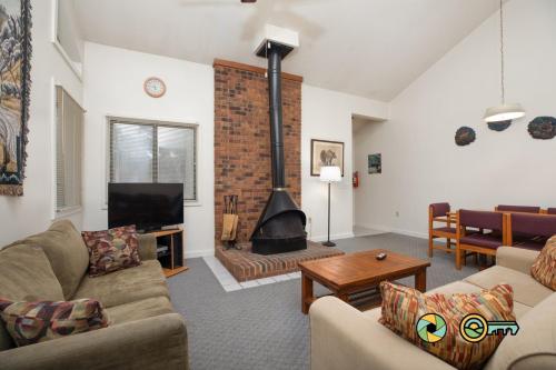 a living room with a couch and a fireplace at Senedo Springs Duplex #97A in Basye