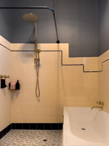 a bathroom with a shower and a tub and a sink at Forrest House Victor Harbor in Victor Harbor