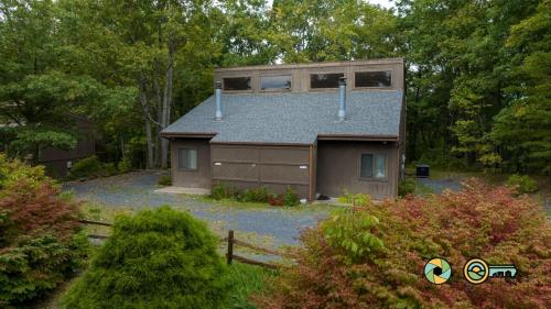 a house with a roof with a garage at Senedo Springs Duplex #97B in Basye