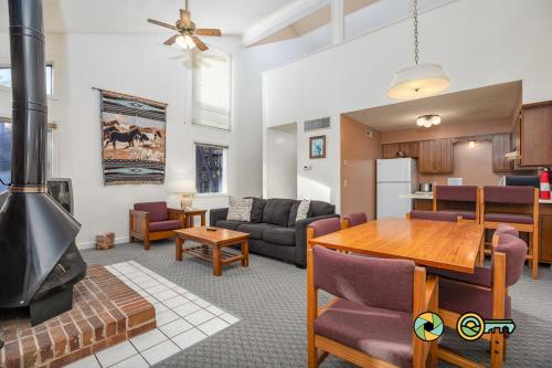 a living room with a table and a fireplace at Senedo Springs Duplex #98B in Basye
