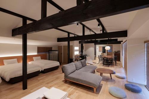 a bedroom with a bed and a couch and a table at marinoe organic resort - Health and Stay - A Private Lakeside Villa at Lake Yamanaka, Blessed by the Spirit of Mount Fuji in Yamanakako