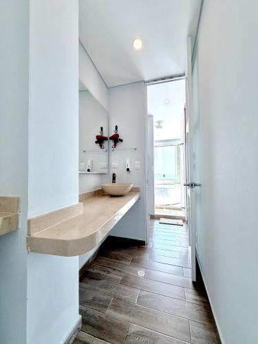 a bathroom with a sink and a large window at Hotel Caribbean Cartagena in Cartagena de Indias