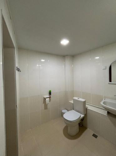 a bathroom with a toilet and a sink at Lucy Apartment Goris in Goris