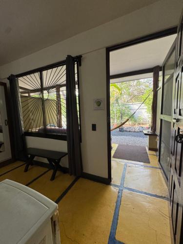 a room with a door open to a room with a bed at Casa del Sol in Tamarindo
