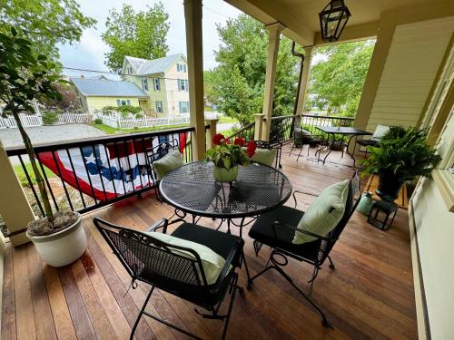 a porch with a table and chairs on a deck at Inn on Turner in Oriental