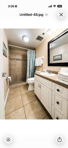 a bathroom with a sink and a toilet and a mirror at Holiday villa 3 in Clearwater Beach