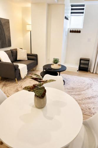 a living room with a white table and a couch at New 2BR Central AC Laundry Private Entry Parking in Milton