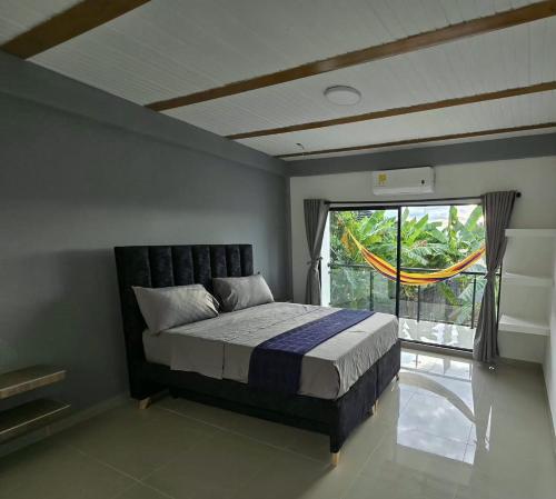 a bedroom with a bed and a large window at Villa Yasmin in Prado