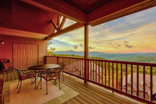 a balcony with a table and chairs and a view at Sugar Sky at The Reserve II in Sugar Mountain