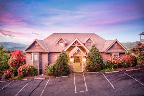 a large house with a driveway in a parking lot at Sugar Sky at The Reserve II in Sugar Mountain