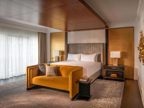 a hotel room with a bed and a couch at The Fairmont Washington DC in Washington, D.C.