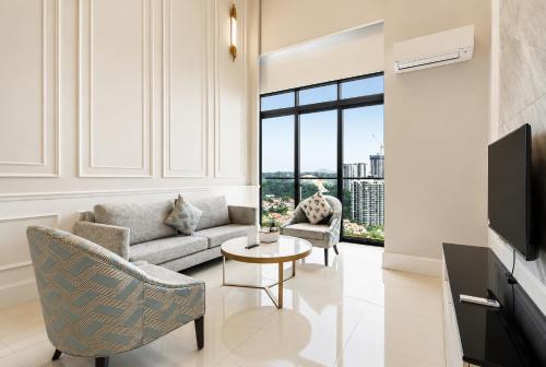 a living room with a couch and a table at Societe Hartamas in Kuala Lumpur