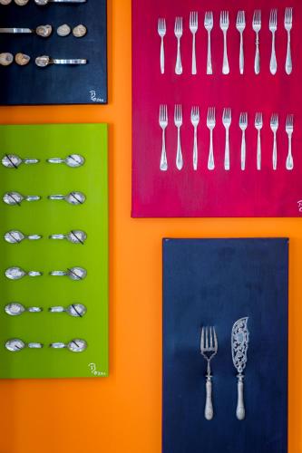 a group of forks and spoons on a colorful background at Bloemenzee Boutique B&B in Gordonʼs Bay
