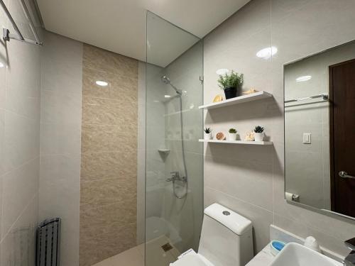 a bathroom with a shower and a toilet and a sink at Ocean Garden Villas 7th Floor - Road Side in Boracay