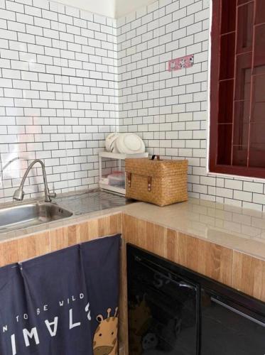 a kitchen with a sink and a counter top with towels at Phuket Hostel at Town in Phuket