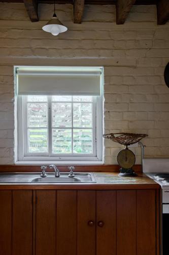 a kitchen with a sink and a window at Woolmers Estate in Longford