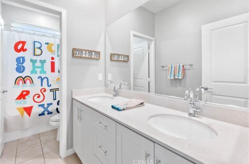 a white bathroom with a sink and a mirror at Bright and Cozy Bay Window Cottage 6 in Ontario