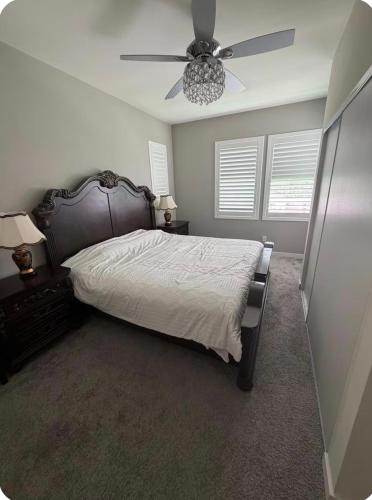 a bedroom with a bed and a ceiling fan at Bright and Cozy Bay Window Cottage 6 in Ontario