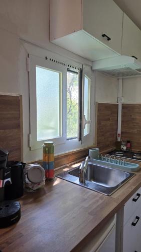 a kitchen with a sink and a wooden counter top at Studio à deux pas de Monaco in Roquebrune-Cap-Martin
