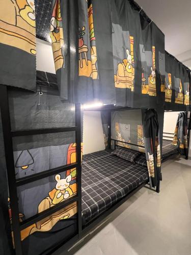 a bedroom with a bunk bed with mickey mouse paintings at Hanoi Backpacker Home in Hanoi