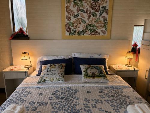 a bedroom with a bed with two pillows on it at Apart Los Cerrillos in Balcarce