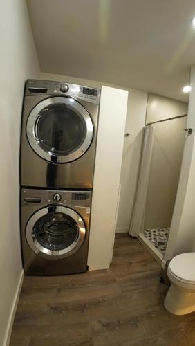 a washing machine in a bathroom with a toilet at Svitanok in Victoria