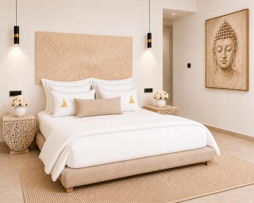 a bedroom with a large white bed with a statue at BLACK AMBER BOUTIQUE HOTEL in Lampi