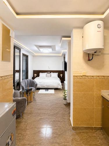 a bedroom with a bed and a living room at Suite BMB in Abidjan